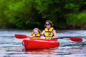 Photo of woman and child in a kayak on a lake